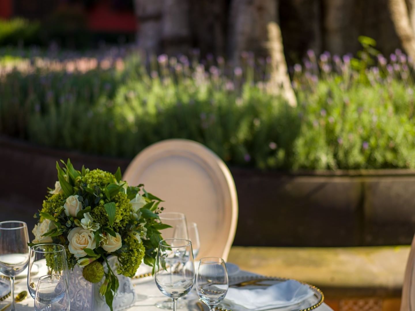 Table with a flower vase, garden patio at La Colección Resorts