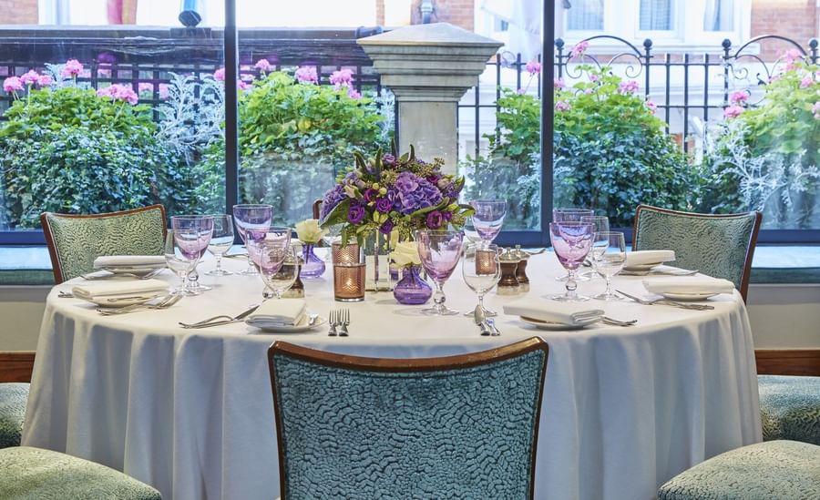 Banquet table with glassware by window in Eaton Suite at The Capital Hotel, Apartments and Townhouse