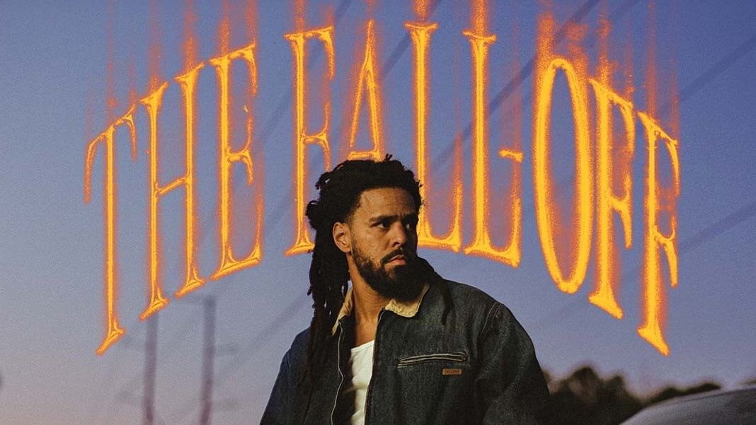 Man with long dreadlocks in denim jacket in front of The Fall-Off poster.