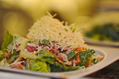 Fresh green salad topped with shredded cheese and diced tomatoes at Farmington Inn and Suites