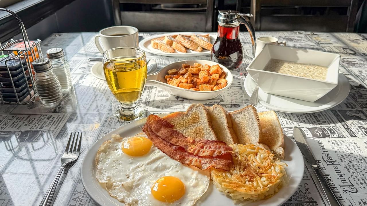 Plate with eggs, bacon, hashbrowns, and toast.