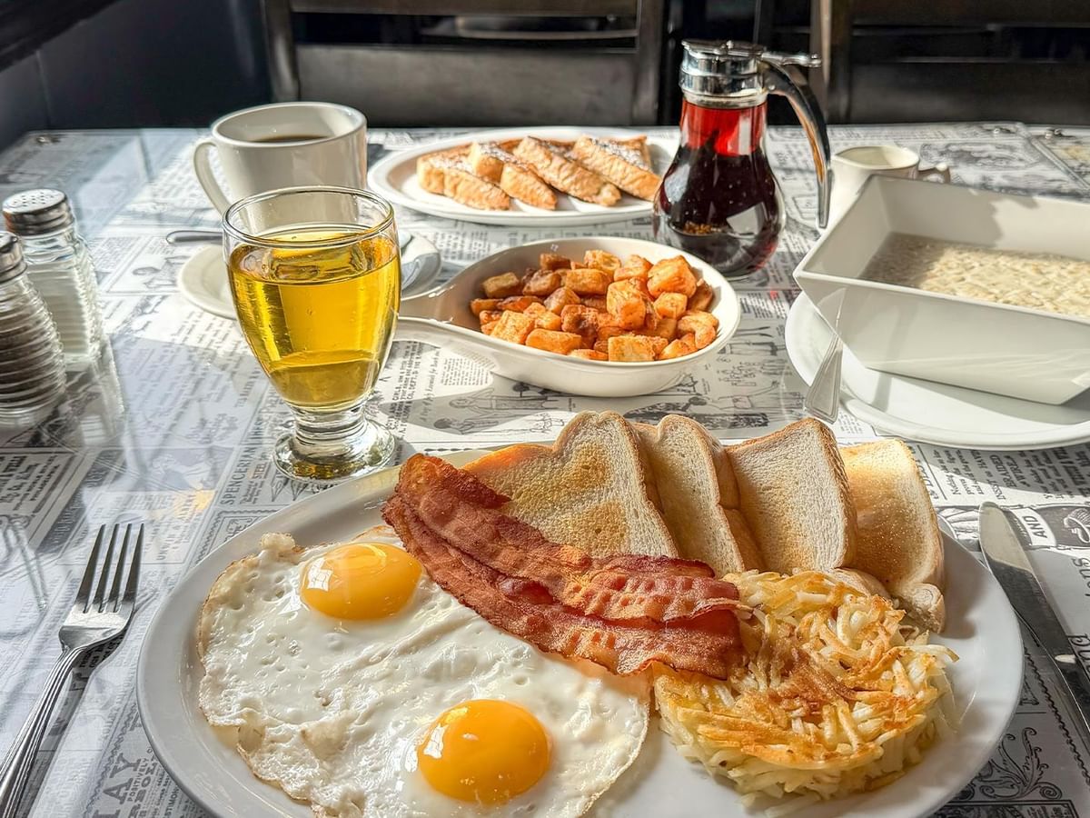 Plate of eggs, bacon, hash browns, and toast.