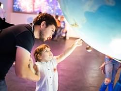 Father & daughter in Planetarium Negara near St Giles Boulevard