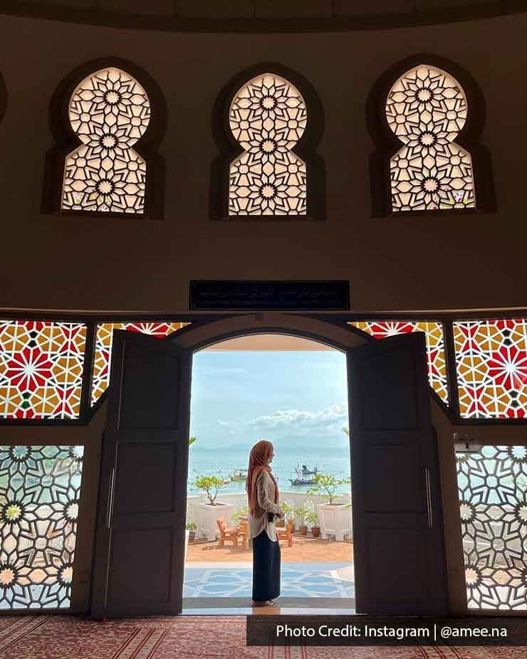 A lady stands in front of the door at the Penang Floating Mosque - Lexis Suites Penang