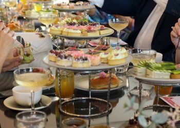 Platters arranged with food and beverages in Private High Tea at Amora Hotel Jamison Sydney