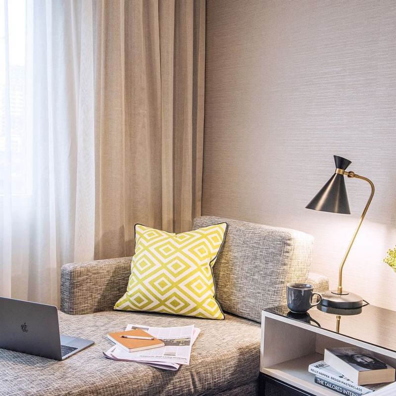 Laptop on a sofa bed in a room at Crown Promenade Perth