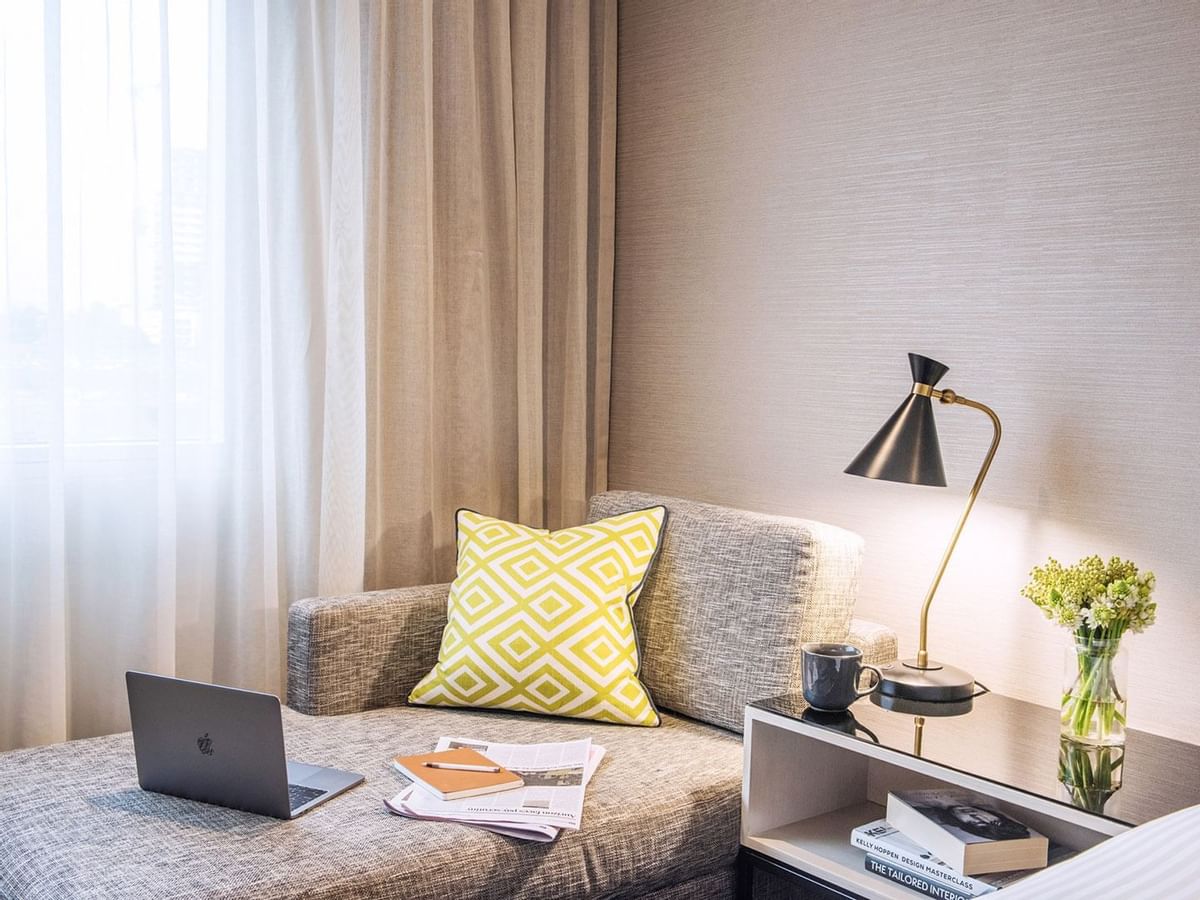 Laptop on a sofa bed in a room at Crown Promenade Perth