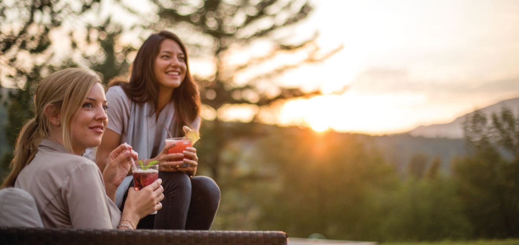 Two women having drinks in the garden at Topnotch Stowe Resort 