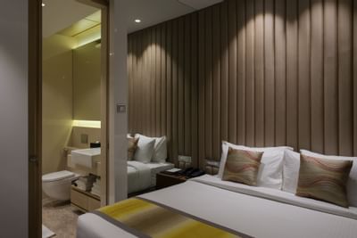 Bedroom with bathroom side view in Suites at Eastin Residences Vadodara