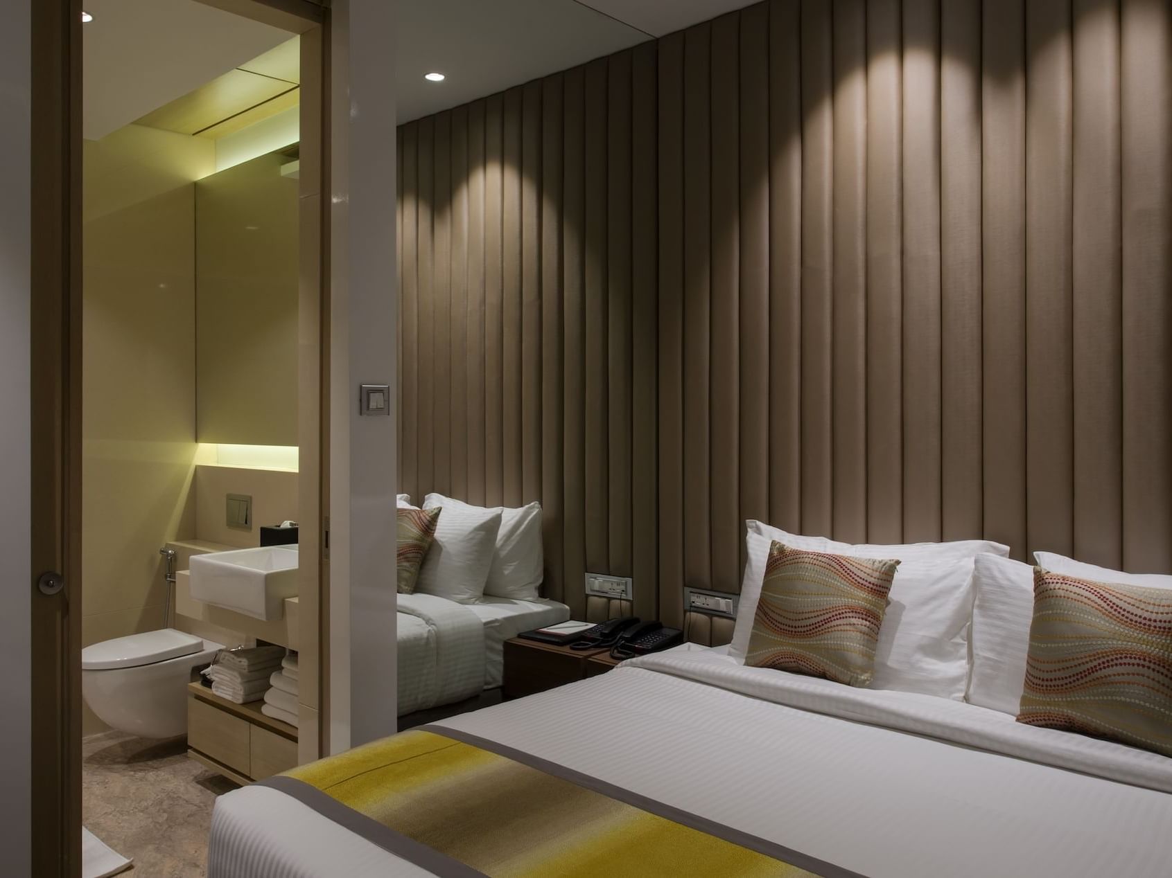 Bedroom with a bathroom side view in Suites at Eastin Hotels