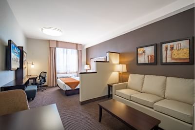 Sofa with a coffee table in a Diamond Studio Suite at Acclaim Hotel Calgary