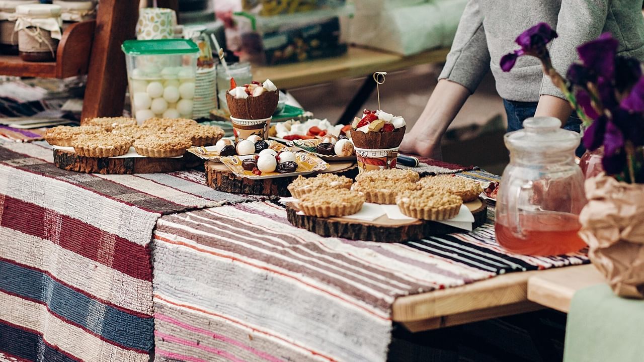 Artisan baked goods and homemade treats displayed on rustic wooden stands