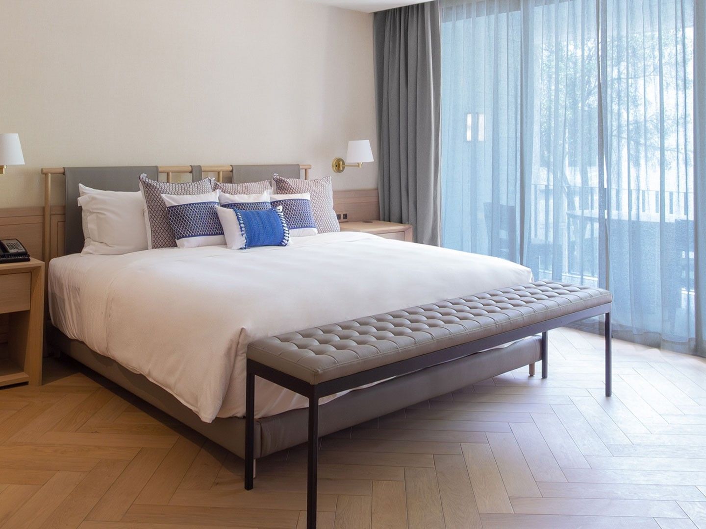 King Superior Viceroys Suite with white linens, blue accent pillows, and light wood flooring at Camino Real Polanco Mexico