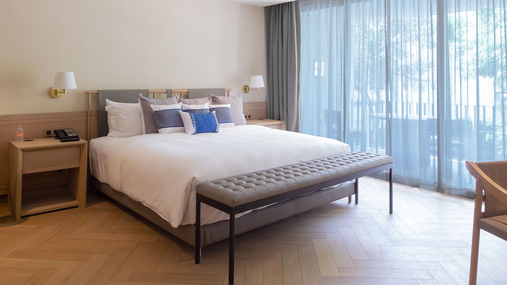 King Superior Viceroys Suite with white linens, blue accent pillows, and light wood flooring at Camino Real Polanco Mexico