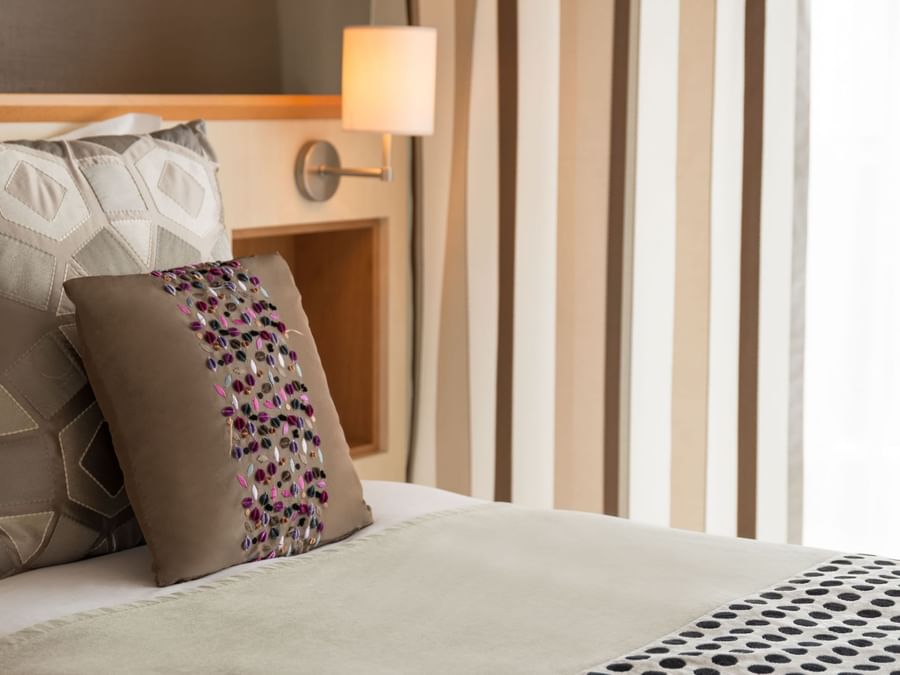 Closeup pillow on bed in a room at Hotel Les Strelitzias