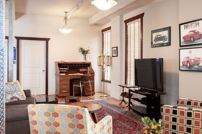 TV lounge area with cozy sofas & working table in Executive Residences at Retro Suites Hotel