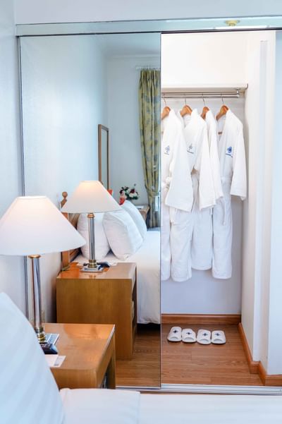 Luxury room with bed, dresser & a mirror at Hanoi Daewoo Hotel