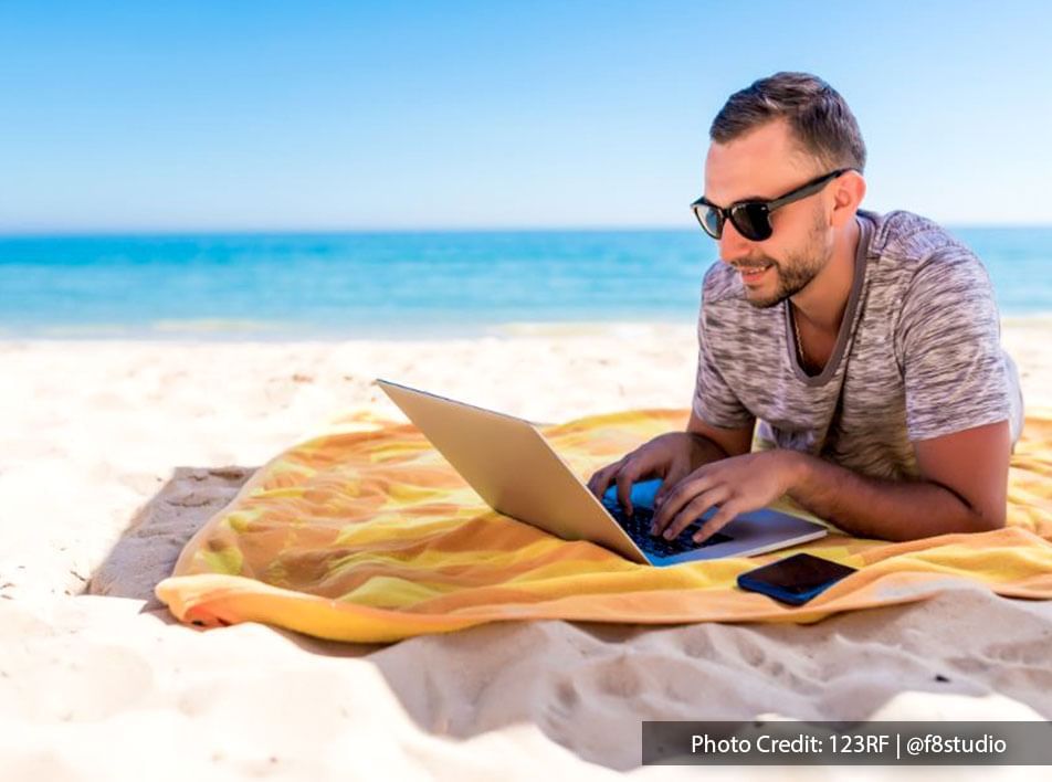 Guy working with his laptop at Lexis Beach Hotel MY