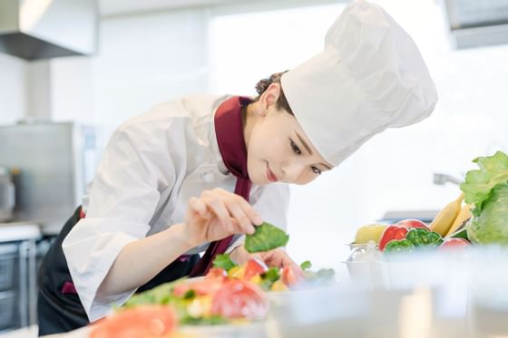 A chief decorating a dish at Federal Hotels International