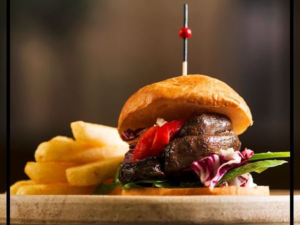 Close-up of a Burger meal served with fries at Pullman & Mercure Brisbane King George Square