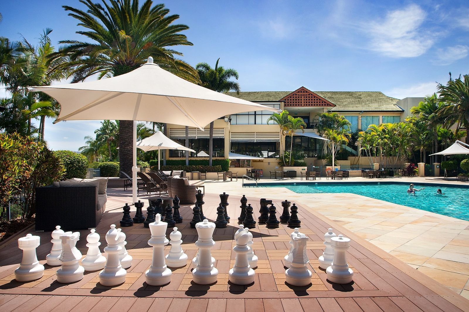Outdoor pool & chess play area at Mercure Penrith Hotel