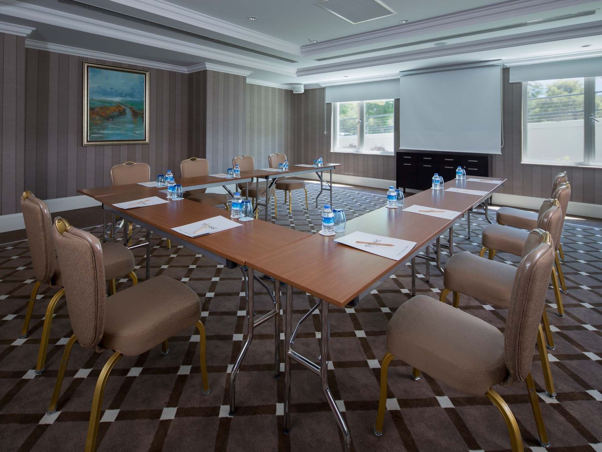 U-shaped table setup with projector screen in Marmara Meeting Rooms at Titanic Deluxe Golf Belek
