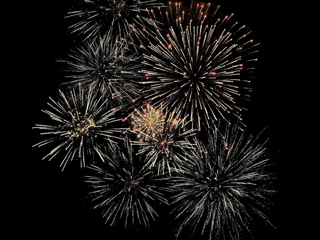 Vibrant celebratory fireworks bursting in the night sky at Warwick Jeddh Hotel & Spa