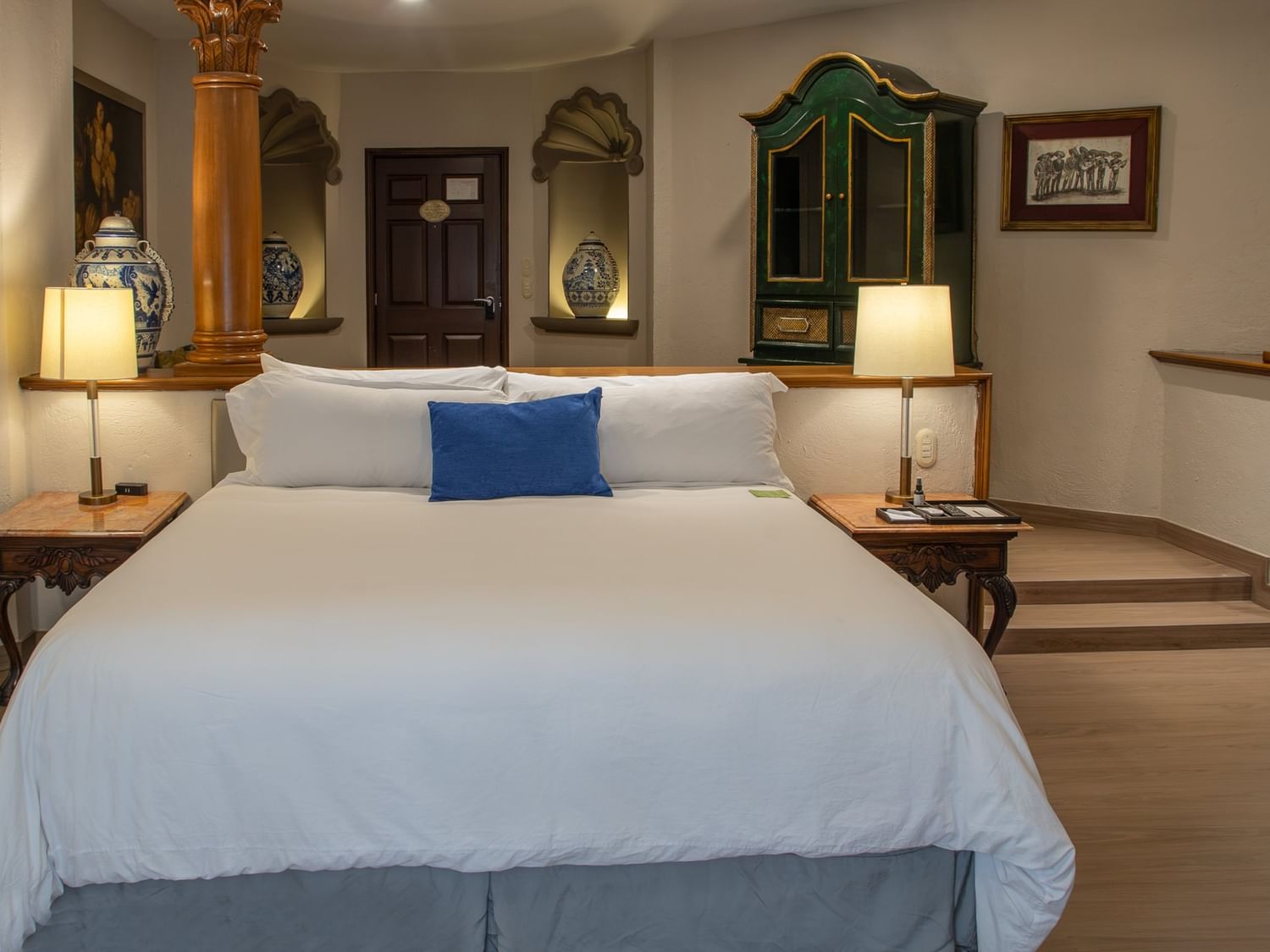 King Grand Class room with white bedding, ornate columns, and traditional Mexican decor at Quinta Real Guadalajara