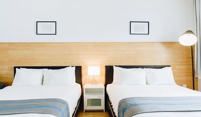 Bedstand between beds in one Bedroom Suite Double at Aqua Hotel
