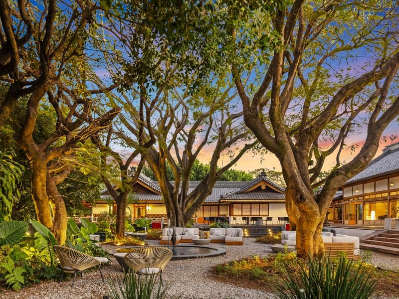 Luxurious outdoor seating area with trees and traditional architecture at Grand Fiesta Americana Sumiya Cuernavaca.