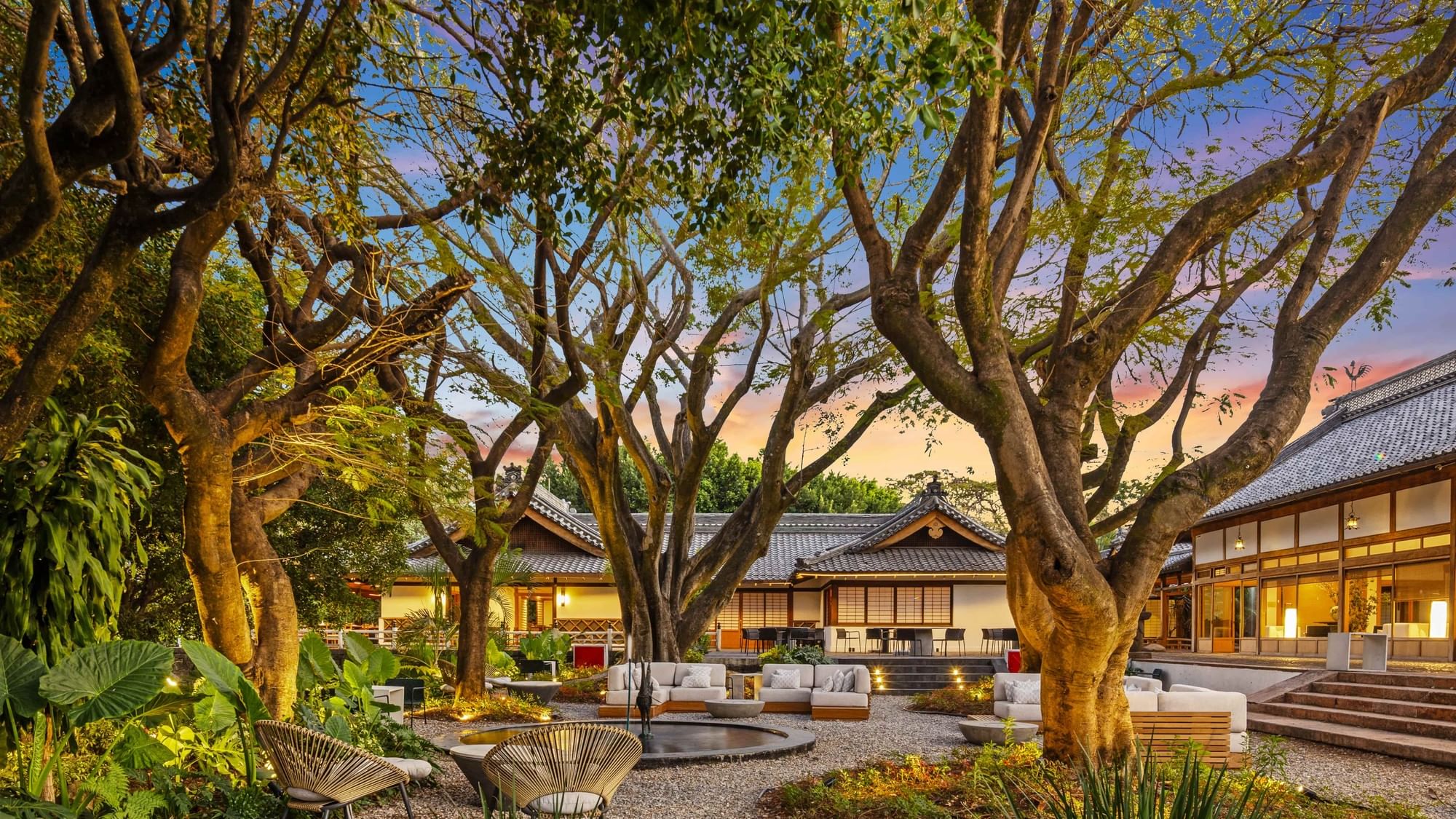 Luxurious outdoor seating area with trees and traditional architecture at Grand Fiesta Americana Sumiya Cuernavaca.