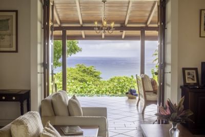 living room with open doors to tropical setting