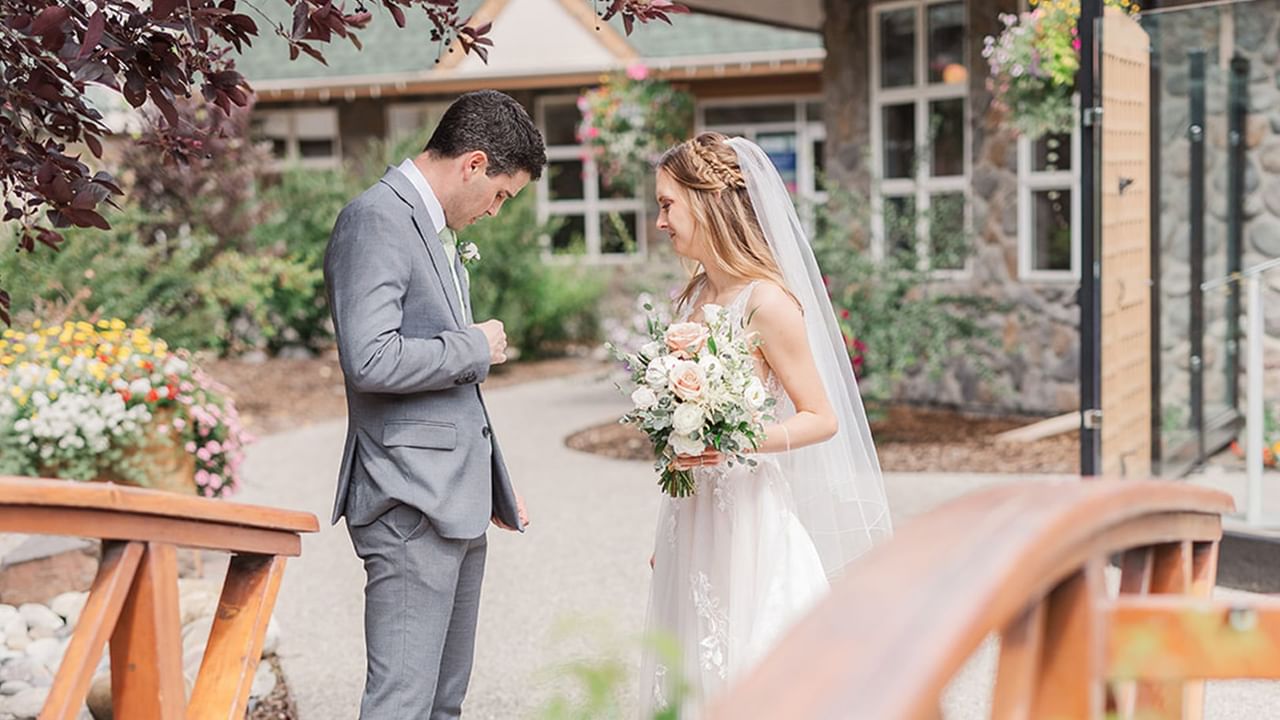 Groom and bride outside of the hotel.