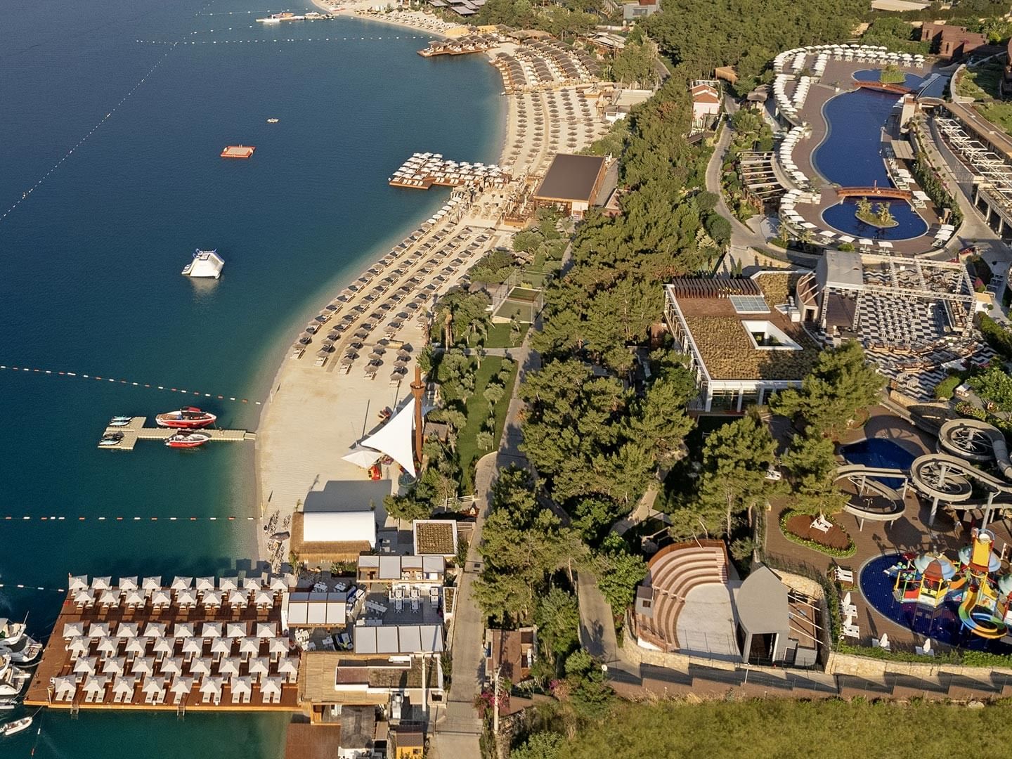 A breathtaking aerial view of Titanic Luxury Collection Bodrum, featuring its beach and pool.
