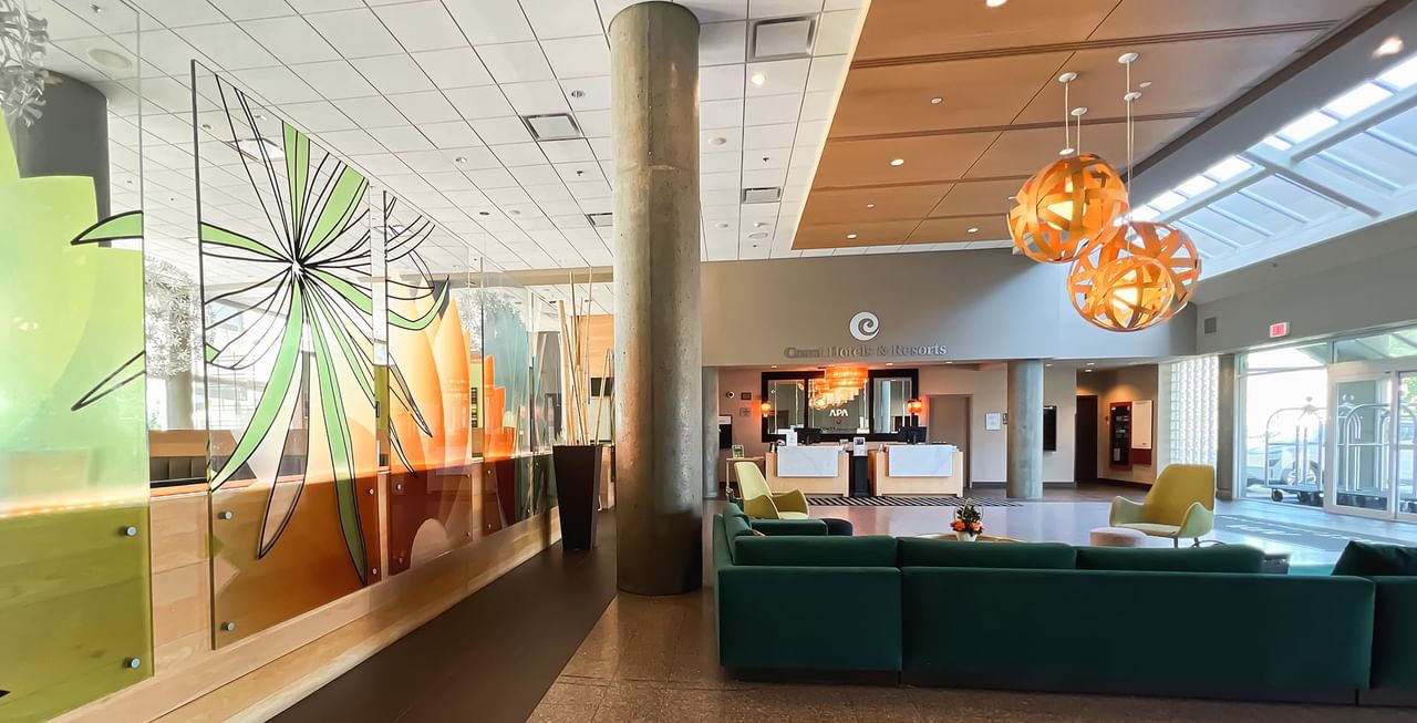 Lobby of hotel with couches, tables, and front desk