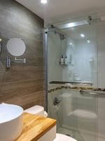 Modern bathroom with a vessel sink and a glass shower in Harbour Premium Balcony at Warwick Paradise Island Bahamas