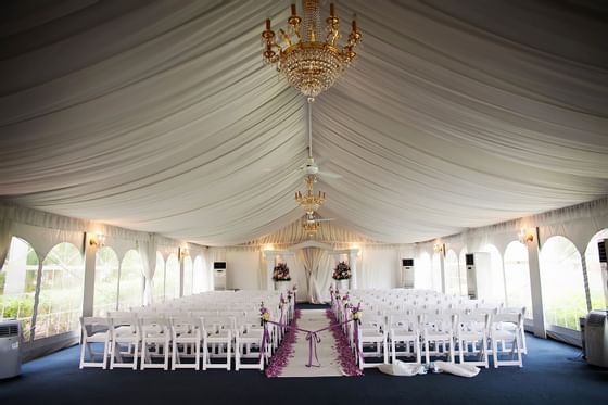 Wedding under canvas tent with chandelier.