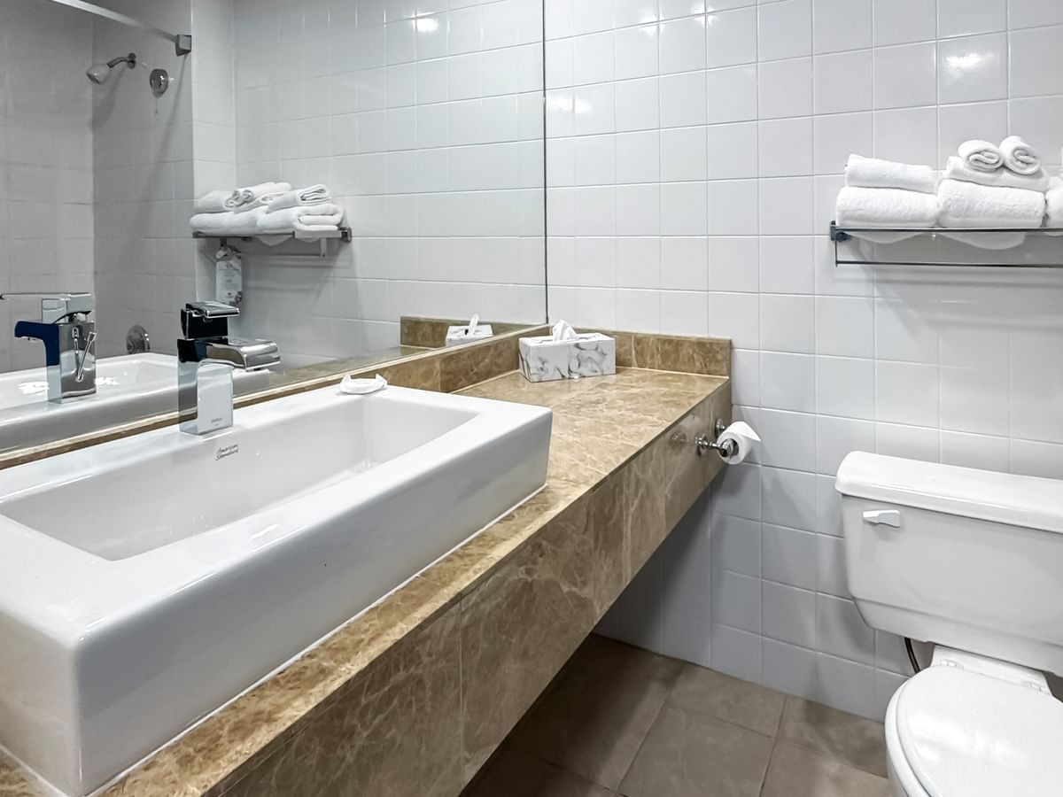 Coast Premium Queen bathroom with white sink, toilet, and towels at Coast Lonsdale Quay Hotel