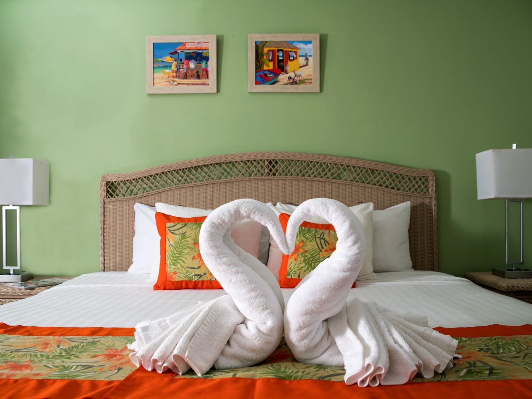 Bed adorned with two towel swans in Studio Family Room at Dover Beach Hotel