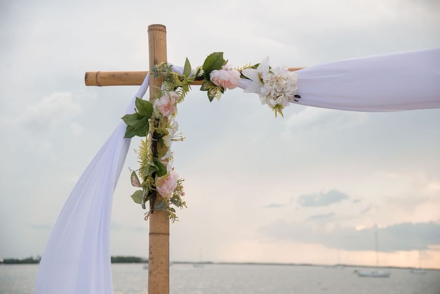 Flowers and cloth hanging on wedding arbor at Bayside Inn Key Largo