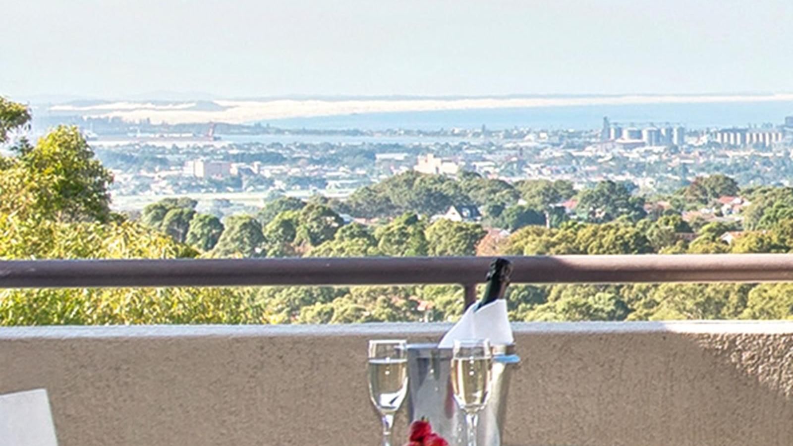 Champagne & strawberries served on the Privilege King room balcony lounge overlooking the city at Mercure Charlestown