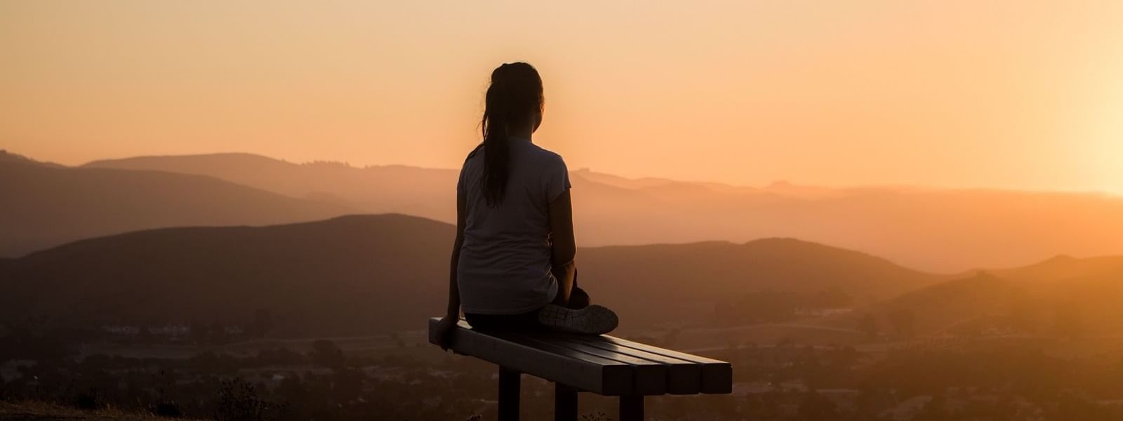 Portrait of a lady enjoying the sunrise view at Crown Hotels