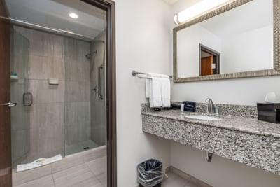 Bathroom with glass-enclosed shower and vanity in King Executive Suite River View at Off Shore Resort
