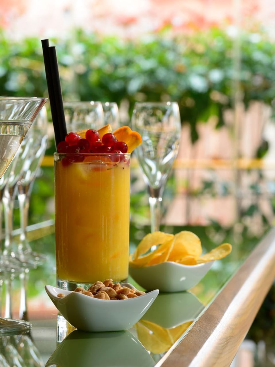 Close-up of cocktails served with chips in Rooftop Terrace Bar at Babuino 181