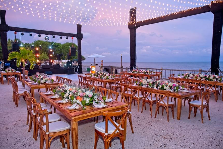 Outdoor wedding ceremony with chairs, and floral deco on the beach near Hotel Isla Del Encanto