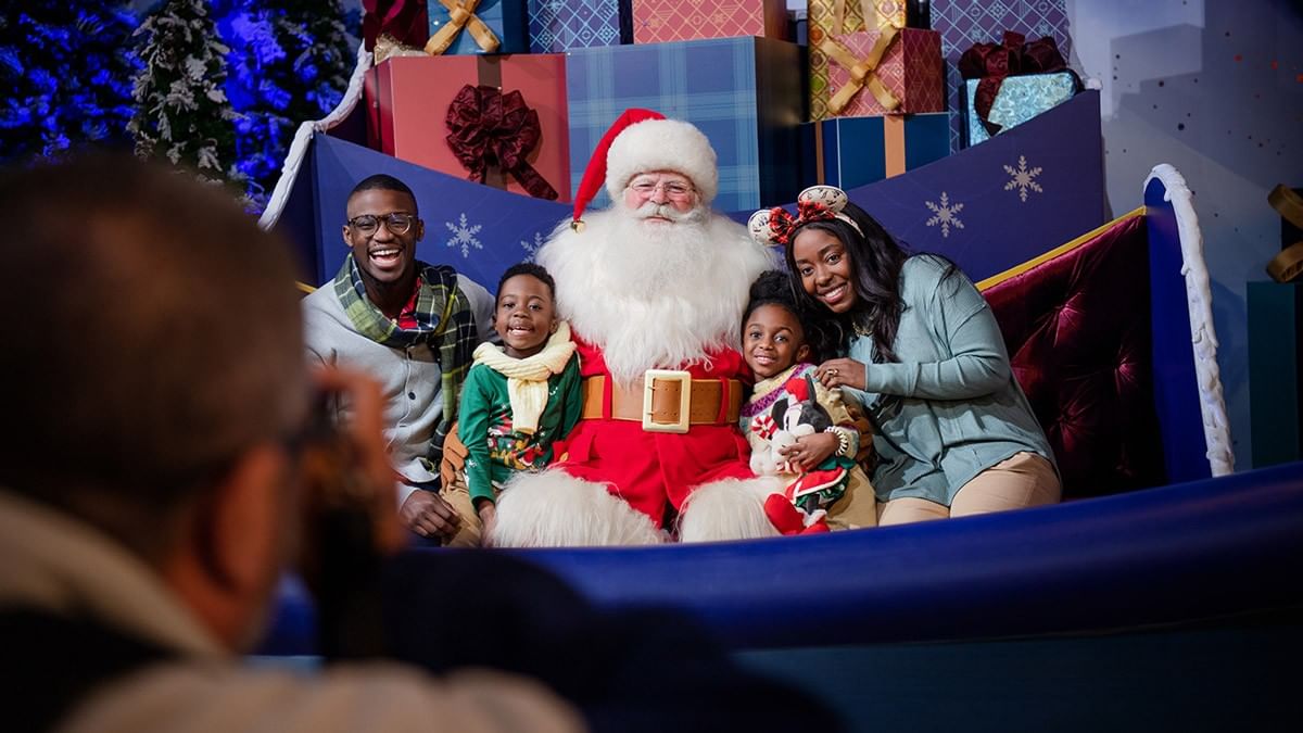 Ladies with candles in hand at EPCOT International Festival near Lake Buena Vista Resort Village & Spa