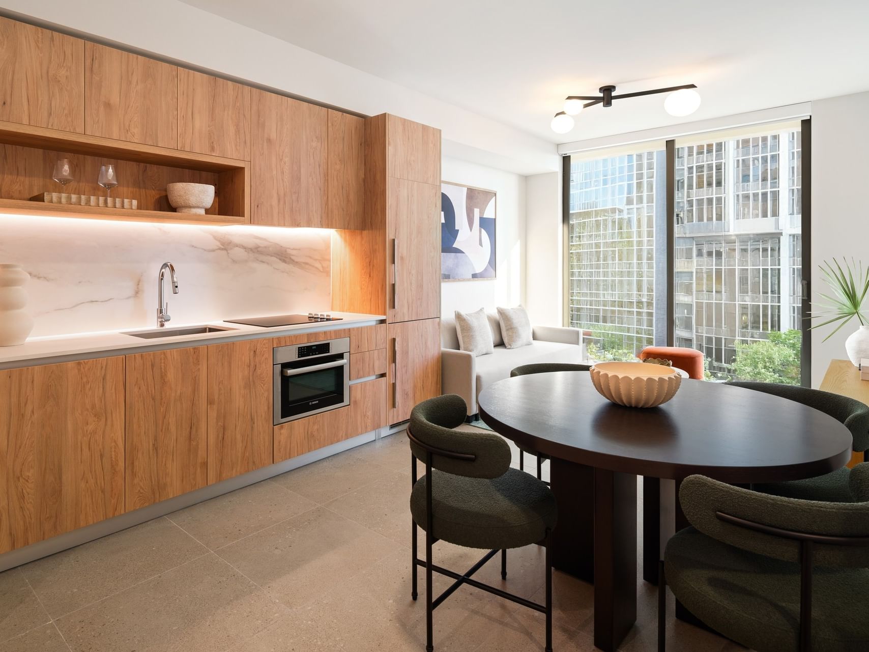 Kitchen with dining table & sofa near window in One Bedroom King Suite at The Crosby Hotel, places to stay in Miami, Florida