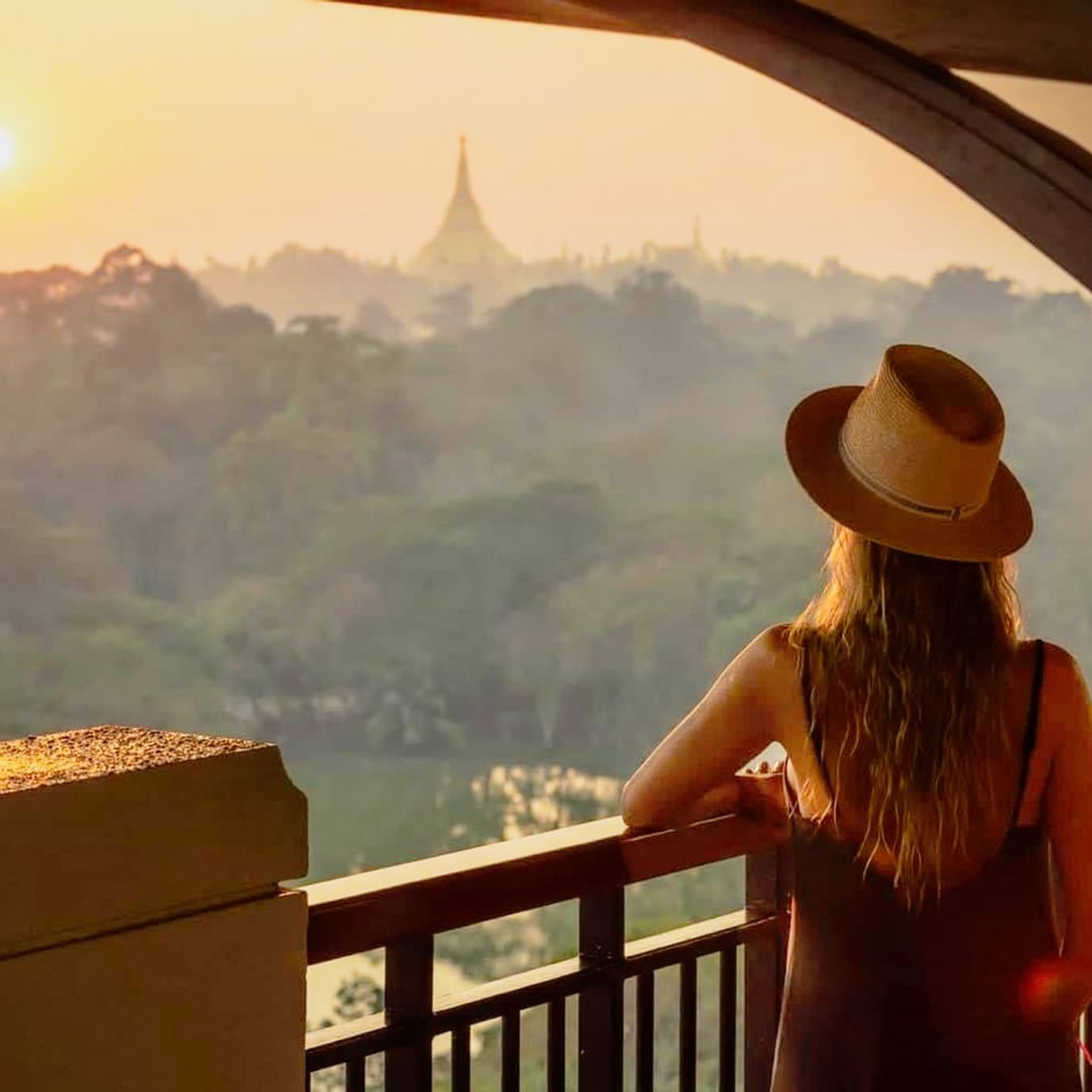 Lady enjoying the balcony view at Chatrium Royal Lake Yangon