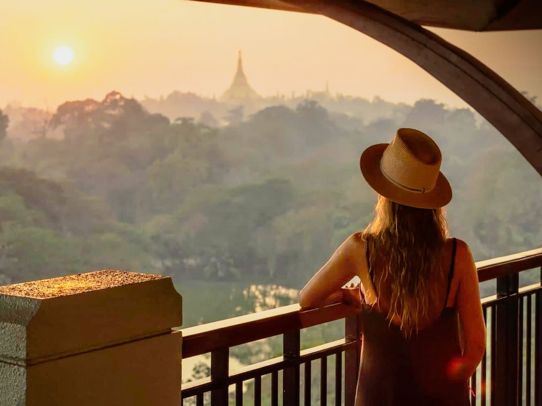 Lady enjoying the balcony view at Chatrium Royal Lake Yangon