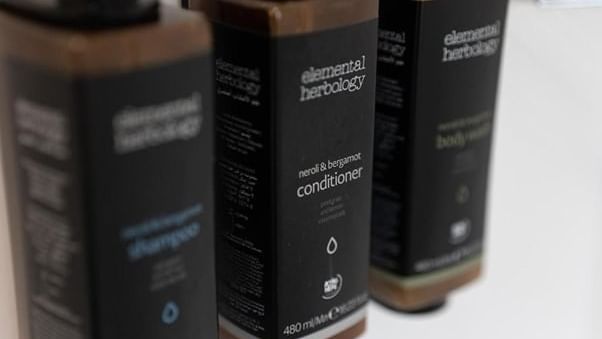 Shampoo, conditioner, and body lotion bottles from Elemental Herbology in Family Room at Mercure Charlestown.